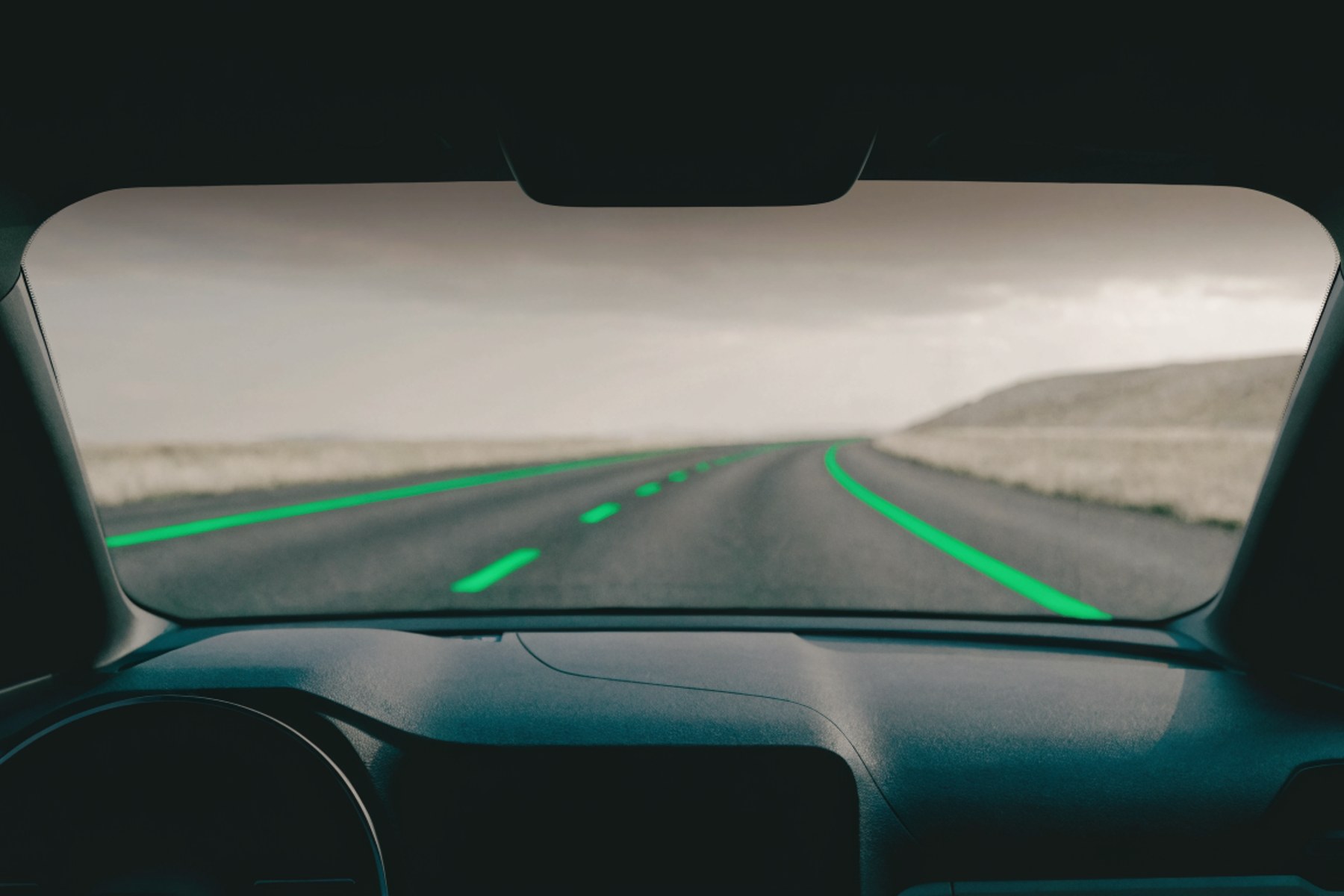 A road ahead from the driver's seat, green lane markings