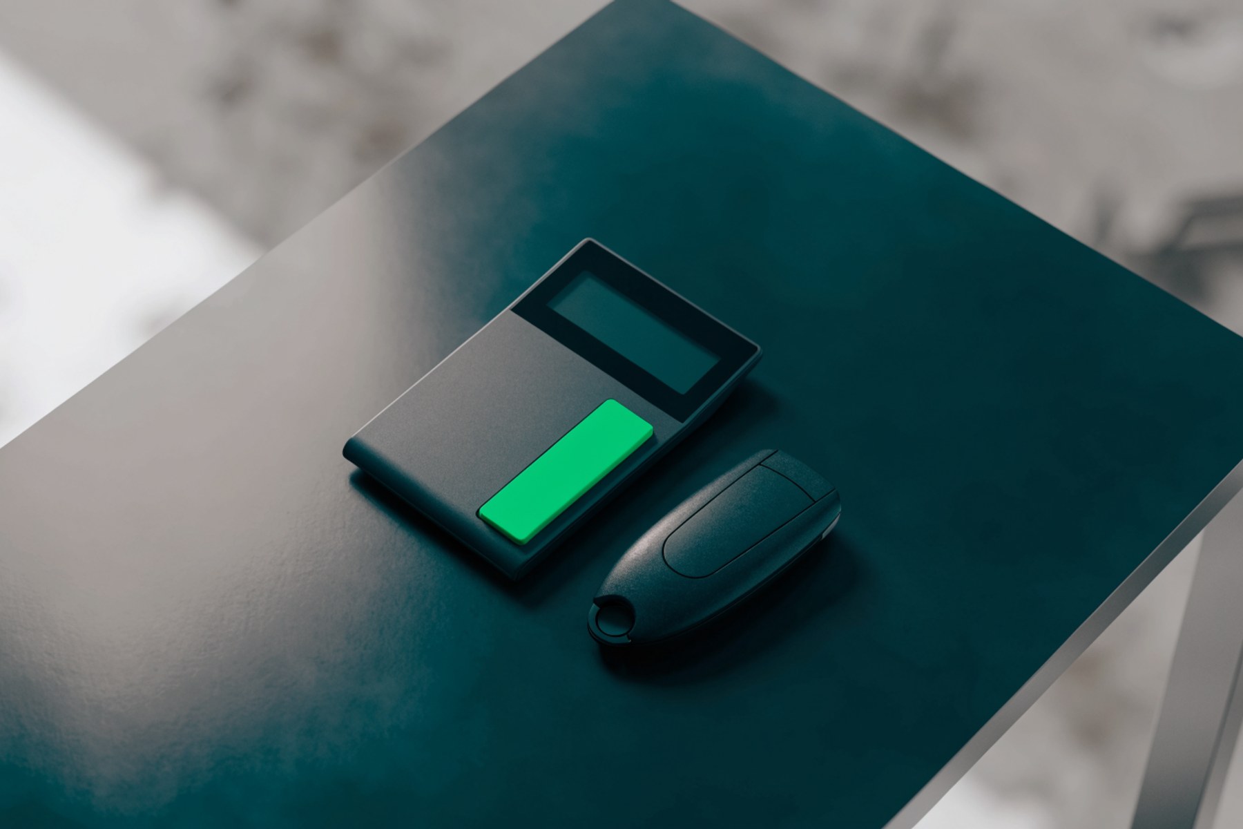 A calculator and a car key on charcoal, green accent